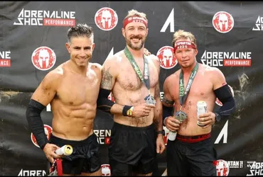 JP, left, celebrates with fellow racers after completing an event. (Image credit: Jean-Pierre Saintard)